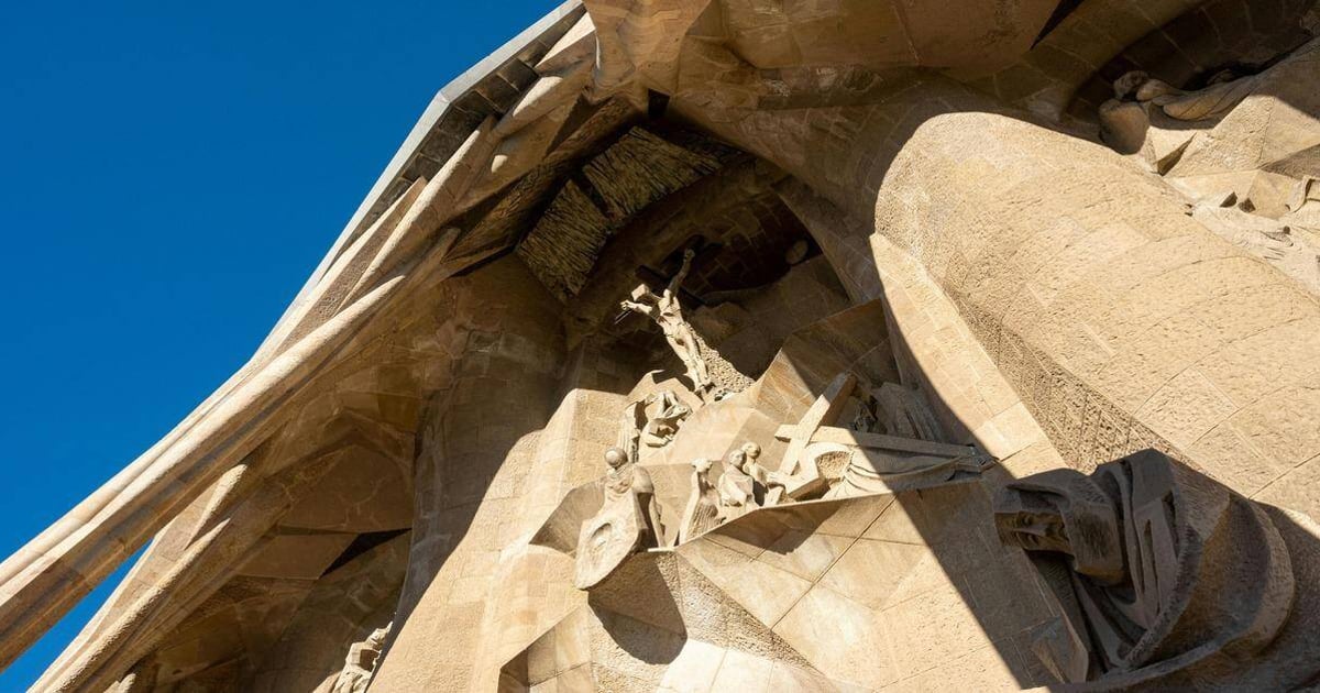 Intricate stone sculptures of religious figures on the Sagrada Familia basilica in Barcelona.