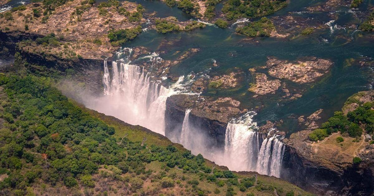 Breathtaking aerial view of Niagara Falls showcasing waterfalls and lush greenery.