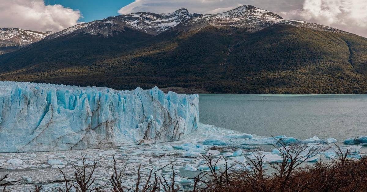 Majestic glacier in Patagonia with snow-capped mountains and icy waters.