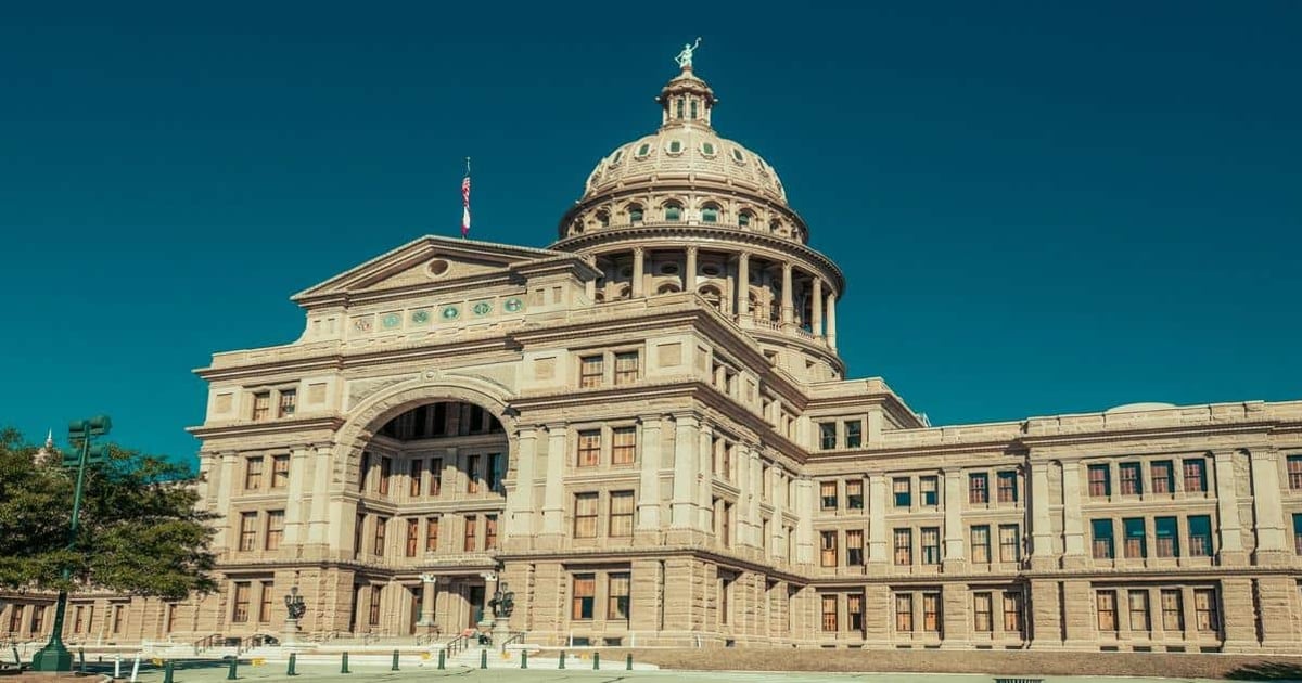 Historic Texas State Capitol building in Austin, Texas, with clear blue sky background.
