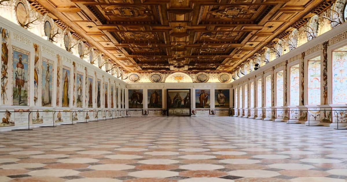 Vatican Museums grand hall with religious paintings and ornate wooden ceiling, iconic cultural destination.