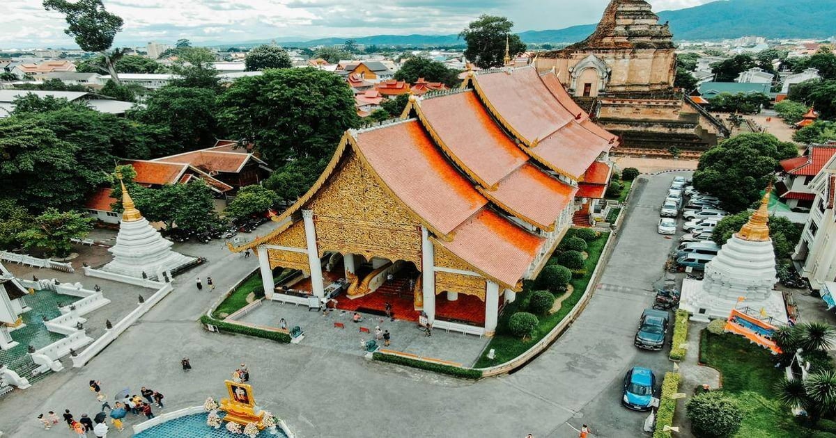 Colorful Thai temple with intricate architecture and lush surroundings in Thailand.