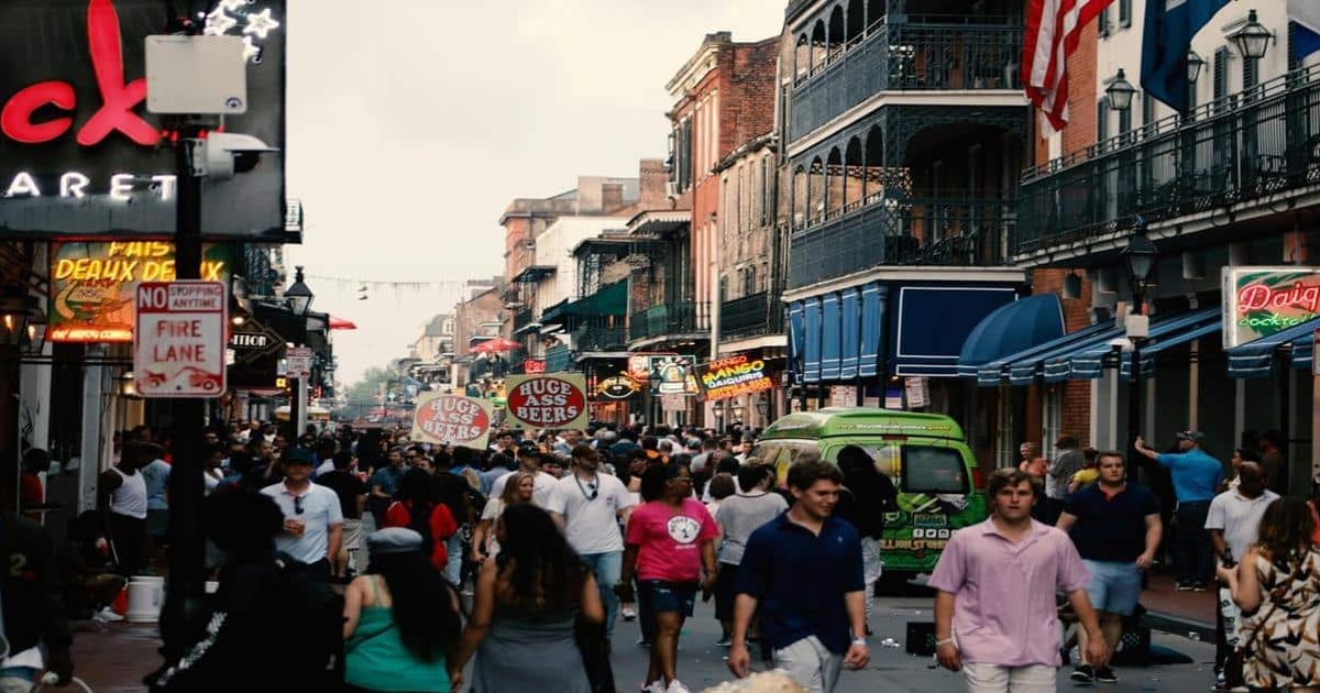 Crowded city street with nightlife, bars, and people enjoying nightlife activities.